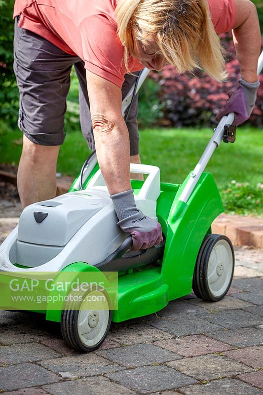 Raising the height of lawnmower blades before cutting a lawn during a dry spell