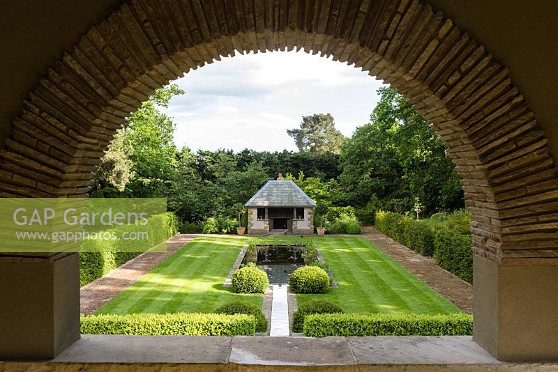 View of the Tranquility Pond and Loggia through the arch of the Thunder House. 