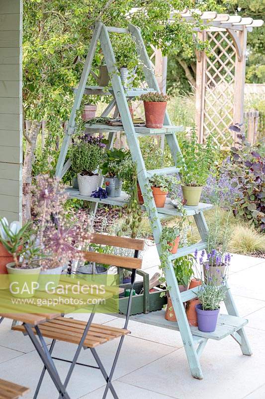 Wooden shelving ladder unit being used as a privacy screen