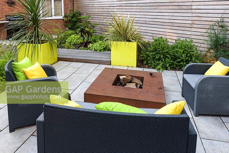 Small Modern Garden with sofa and armchairs around fire pit