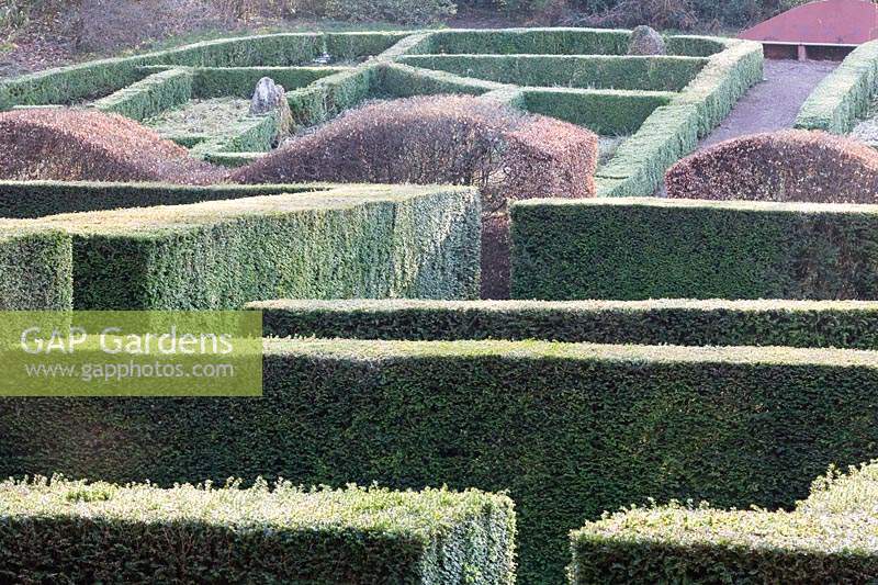 View from the Windfall Garden to the Grasses Parterre. Low hedges of clipped Buxus Sempervirens 'Box', Wave-form hedge of Fagus Sylvatica 'Beech', High hedges of Taxus baccata 'Yew'. 