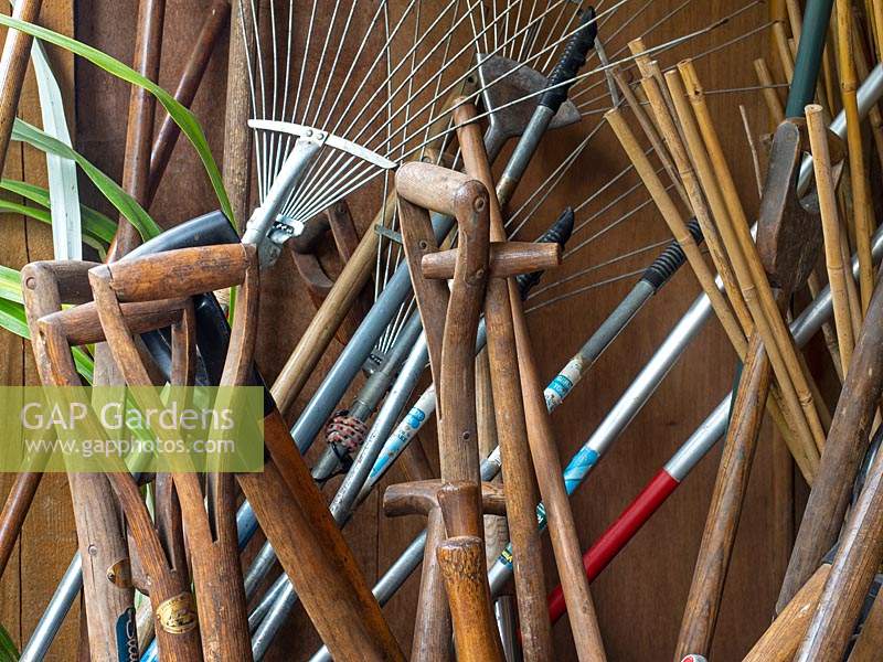 Traditional garden tools stored in potting shed. 
