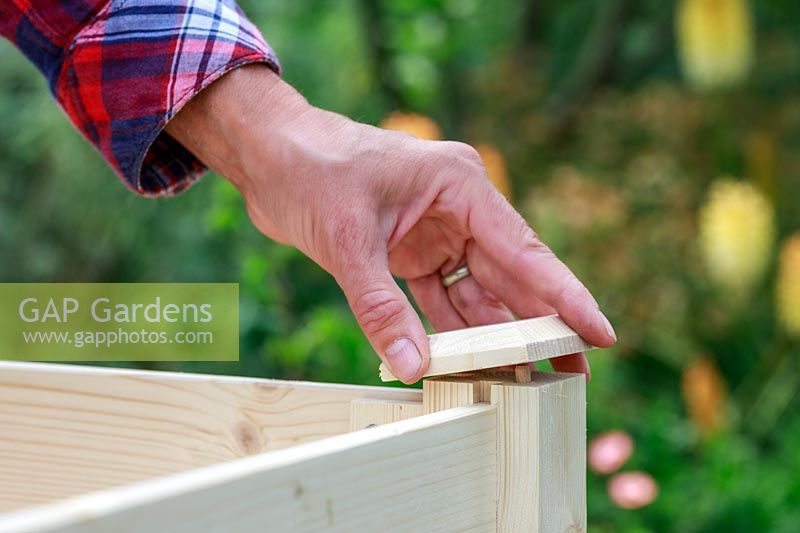 Placing a finial onto the ends of a wooden planter