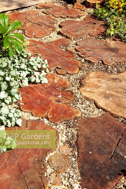 Path made with slices of tree trunk with wood chip infilling - RHS Malvern Spring Festival