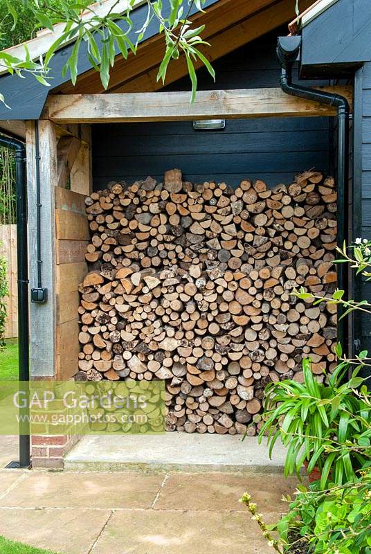 Firewood neatly stored under cover - Open Gardens Day, Great Finborough, Suffolk