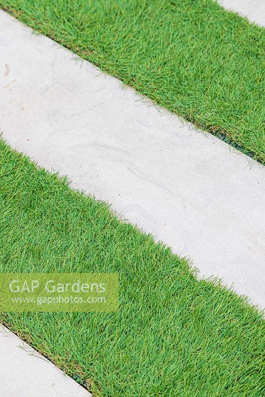 Detail of Stepping stone path across artificial lawn