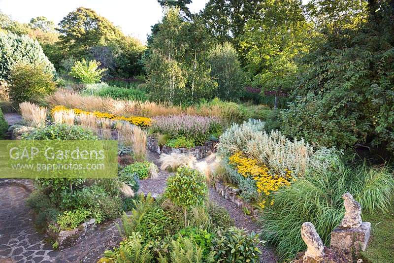 Aerial view of front garden with ornamental grasses and herbaceous perennials.