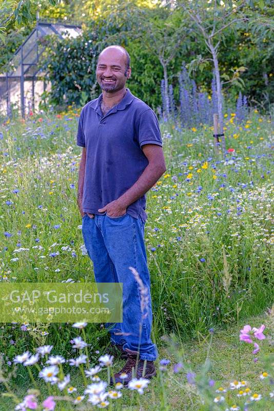 Guru Sharma in the wild flower meadow garden he helped to create. 