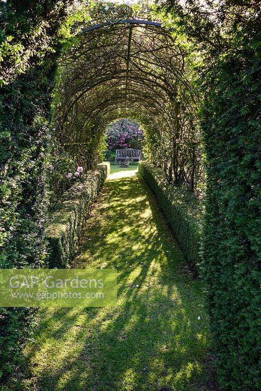 View through rose tunnel to bench in The Secret Garden, 


