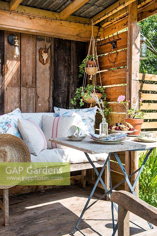 Rustic furniture on verandah including cushions