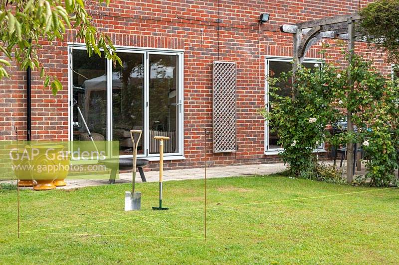 Area outside house marked for clearing with yellow string