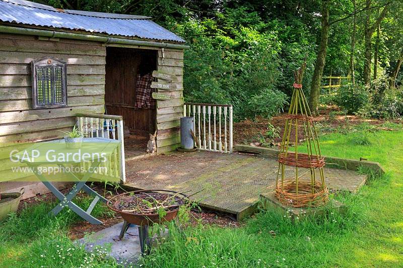 Shed used as summerhouse in the paddock. Sign says 'welcome to our cottage'.