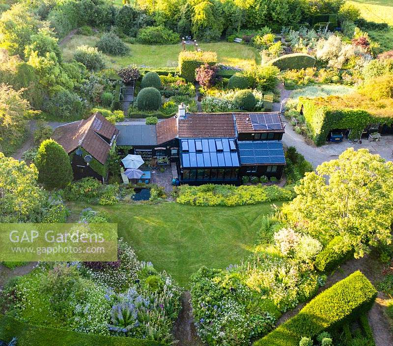 Image taken from drone giving overview of house and garden with its different rooms 