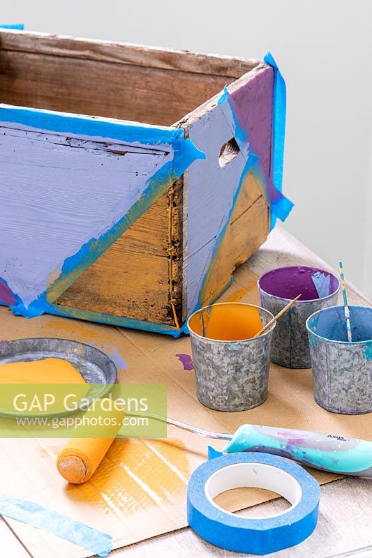 Wooden box painted with multicoloured geometric shapes