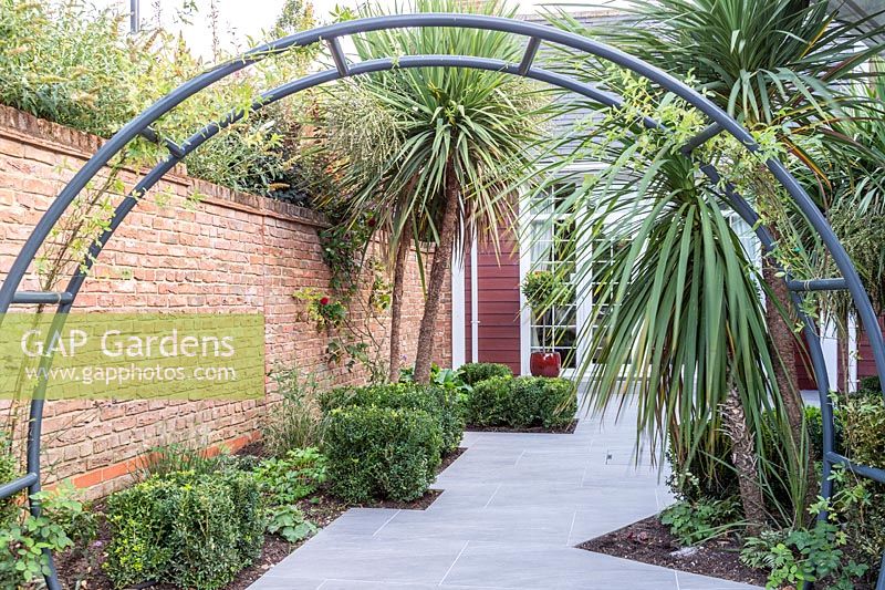 Circular metal arch framing an irregular walkway