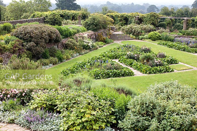 View overlooking a large sunken parterre laid out with geometric borders edged with stone