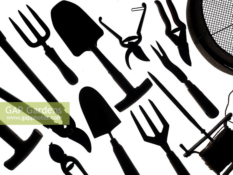 Collection of  garden tools on a white background Secateurs, garden Sieve seed dibber fork loppers and hand Trowels