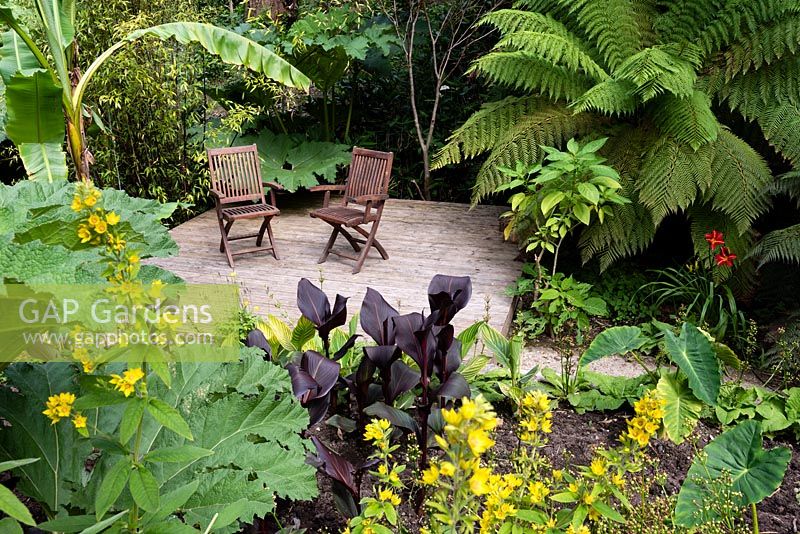 Decked area with seating in an exotic garden
