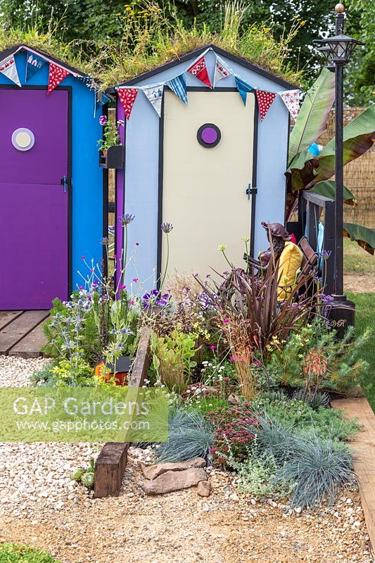 Colourful beach huts with wildflower green roofs. Fun on Sea, RHS Hampton Court Palace Flower Show, 2017. Design: Tony Wagstaff. 