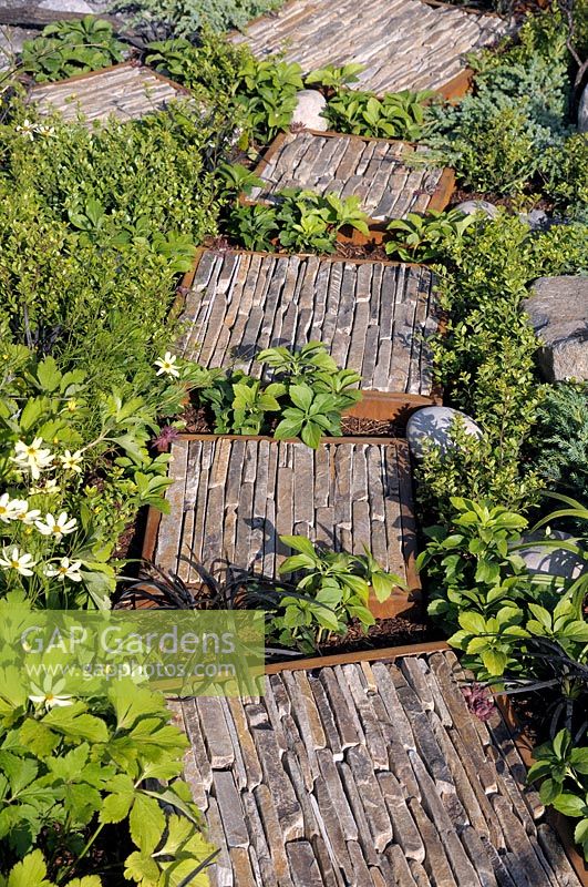 Path detail with cut stone in corten steel frames softened with foliage - Through Your Eyes - RHS Hampton Court Palace Garden Festival 2019