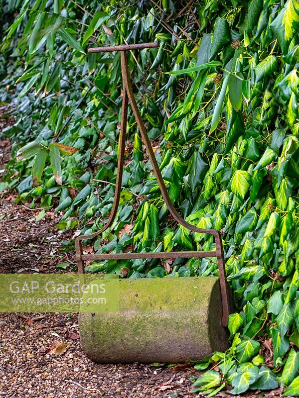 A vintage garden roller at East Ruston Old Vicarage garden, Norfolk, UK. 