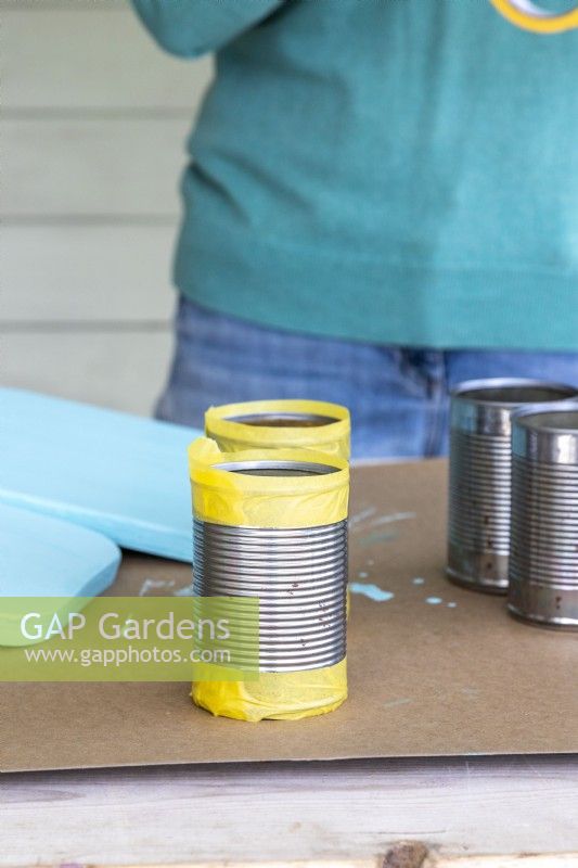 Tin cans with masking tape on the top and bottom