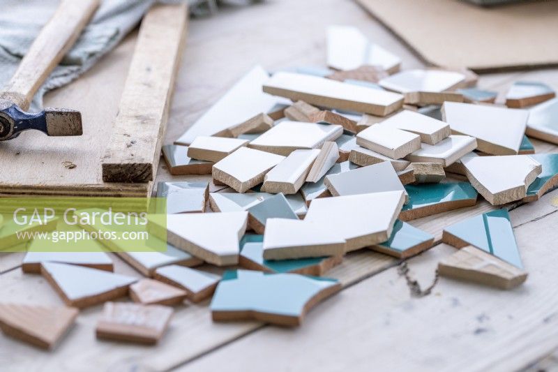 Smashed tiles laid across a wooden surface