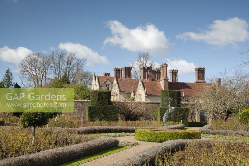 A view over the rose garden to the Elizabethan manor house in spring at Borde Hill Garden.
