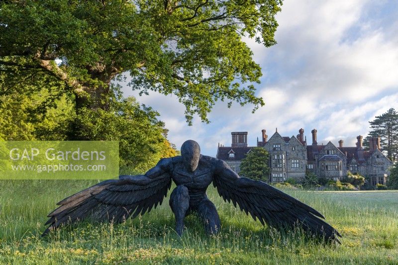 Sculpture of an angel kneeling on the south lawn - June