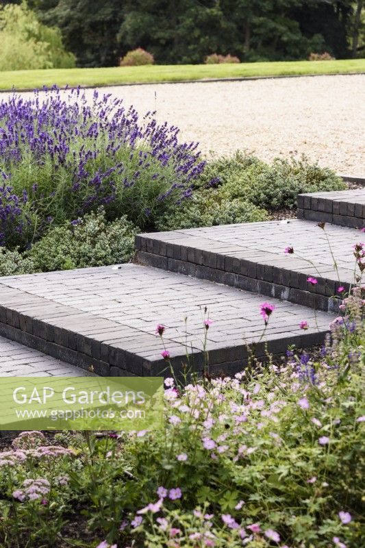 Steps of Lucca brick pavers made by Chelmer Valley, in a contemporary garden in July