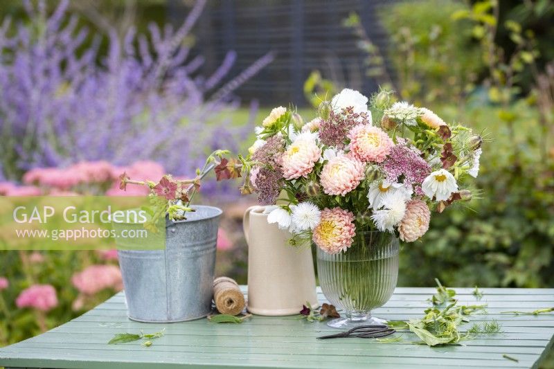 Arrangement of Callistephus 'Duchesse Apricot', Daucus carota 'Dara', Amberboa moschata 'The Bride', Nicotiana langsdorfii 'Bronze Queen', Cosmos 'Fizzy White', Nigella seed pods in a glass vase