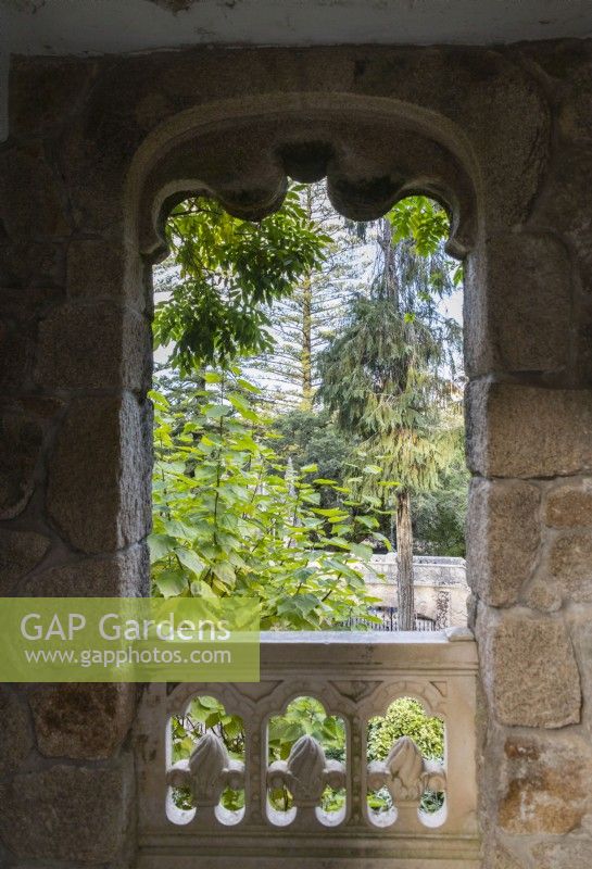 View through stone window onto the garden. 