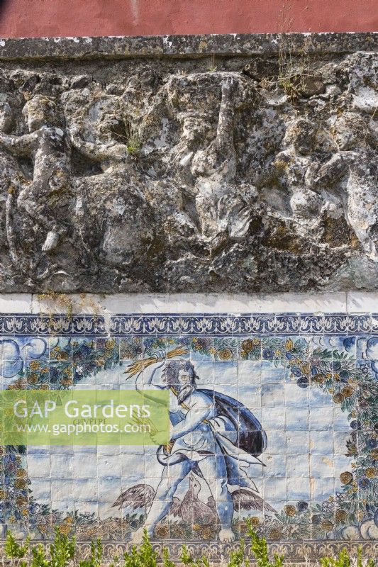 Detail of the wall of the Formal Garden with glazed tiles or Azuljelos depicting the harvest and raised sculpture of figures in wall above. Lisbon, Portugal, September.