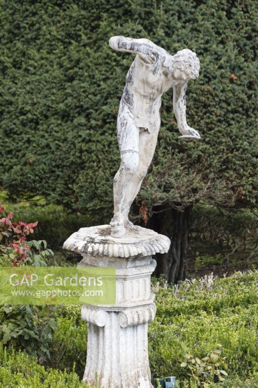 Lead sculpture on man on plinth on the Formal Garden. Lisbon, Portugal, September.