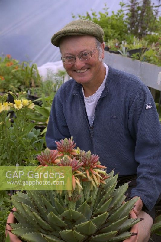 Nurseryman Malcolm Allison with Aloe polyphylla in his propagation polytunnel, Gloucestershire