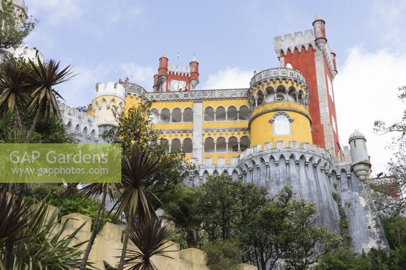 View of the Palace from the entrance with trees in foreground.  Parque da Pena, Sintra, near Lisbon, Portugal, September.