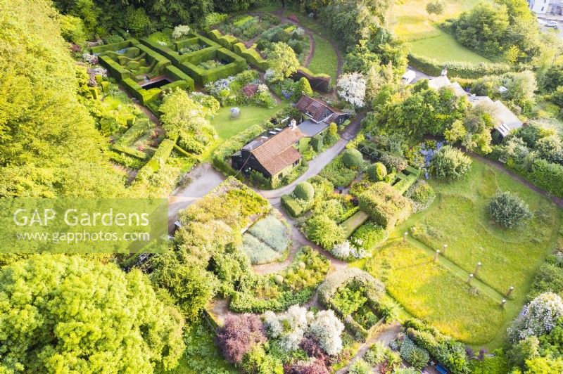 View over the whole garden with house in centre; image taken with drone. July. Summer.