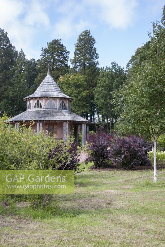 Wooden garden-shelter/summerhouse in Arboretum at Dumfries House.  September. Summer.