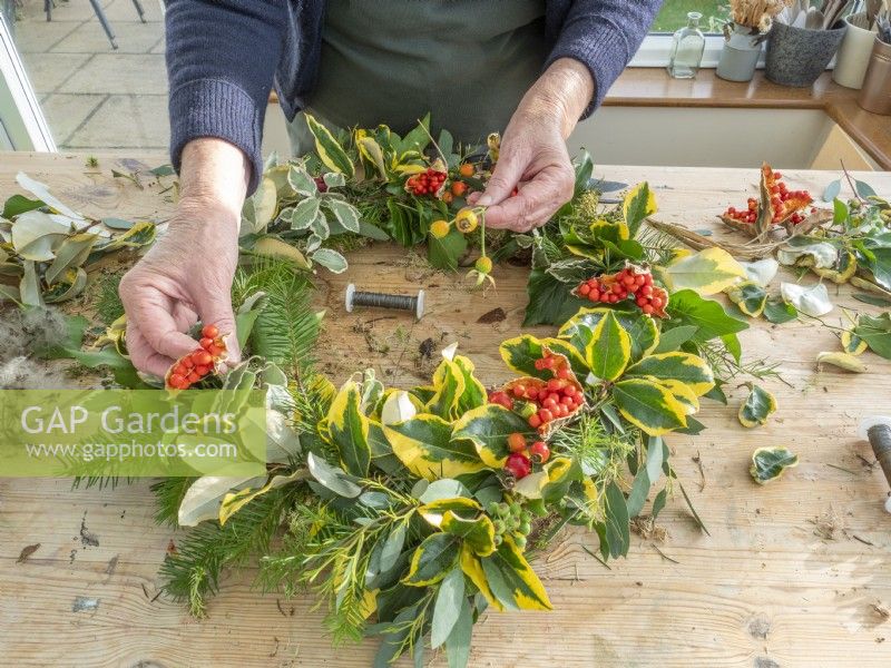 Add berries to completed Christmas wreath