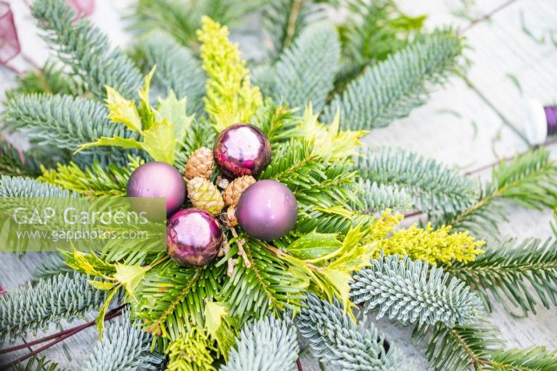 Decorative evergreen star lying on wooden surface