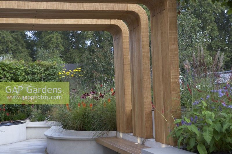 Finding Our Way: An NHS Tribute Garden. Designer: Seating area with modern timber canopy. Naomi Ferrett-Cohen. Chelsea Flower Show 2021.