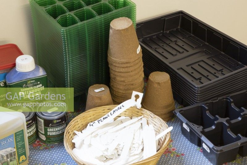 A variety of gardening sundries including seed trays, compostable plant pots, labels and greenhouse shading paint and fumigator. 
