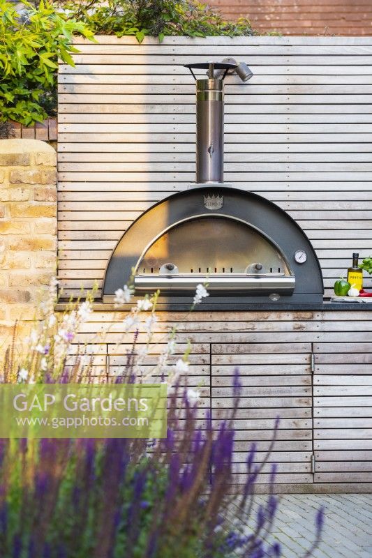 Bespoke kitchen unit with integrated pizza oven and storage. 