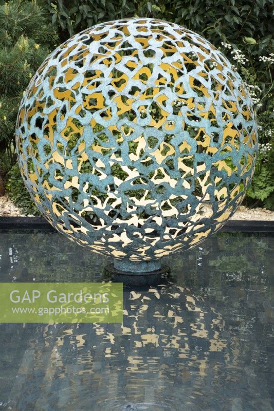Globe water feature in the 'A Peaceful Escape' Show Garden at the RHS Spring Festival 2022 - Garden Designer James Langlands  - Silver Gilt Medal Show Garden