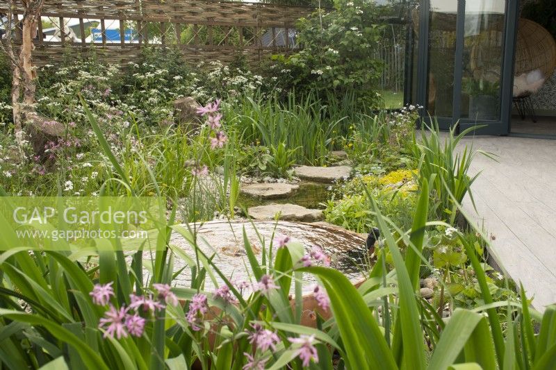 Fountain and stream in 'The Hide Garden' at the RHS Malvern Spring Festival 2022  - Designer - Emily Crowley-Wroe - Best in Show - Silver Gilt Medal