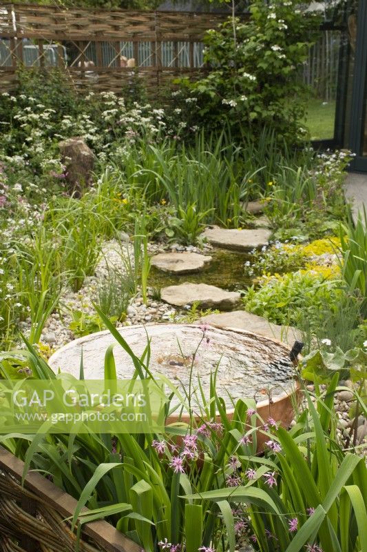 Fountain and stream in 'The Hide Garden' at the RHS Malvern Spring Festival 2022  - Designer - Emily Crowley-Wroe - Best in Show - Silver Gilt Medal