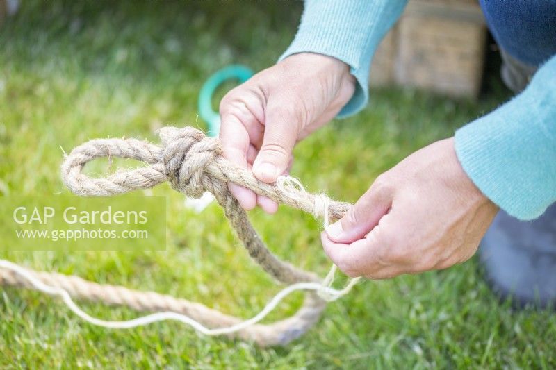 Woman binding the end of a piece of rope