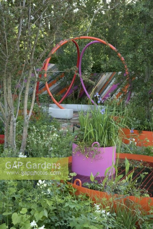 Urban community garden with bright, colourful landscaping and container planting