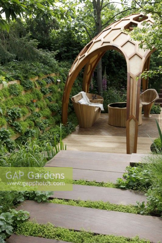 In The Meta Garden: Growing The Future, the steps leading to the sunken area are interspaced with moss, Selaginella kraussiana and bordered with woodland strawberries, Fragaria vesca - Designer: Joe Perkins - Sponsor: Meta.