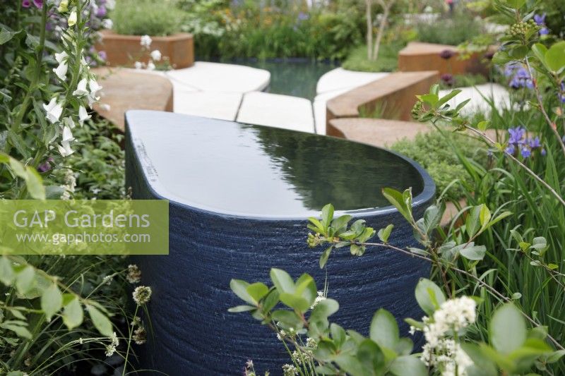 View of the drop-shaped water feature in the BBC Studios Our Green Planet and RHS Bee Garden - Designer: 